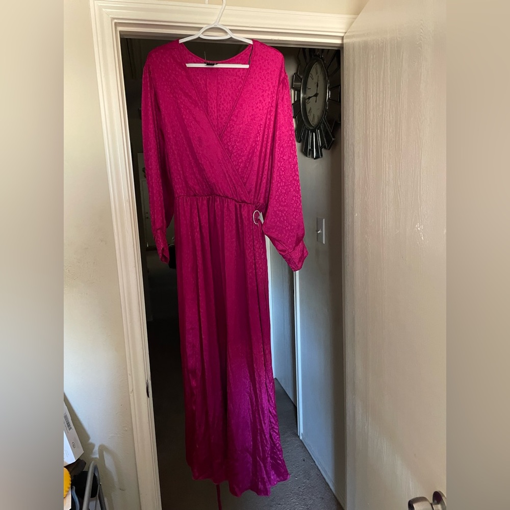 Beautiful long sleeve fuchsia wrap dress with diamond brooch at the waist.
